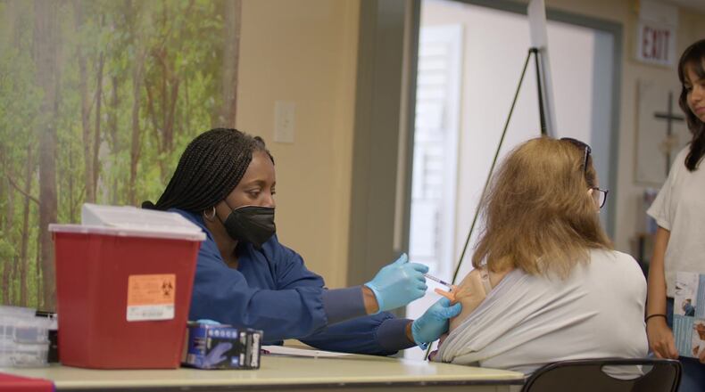 A patient gets a shot at a "pop-up doc" clinic meant to help workers who don't have insurance.