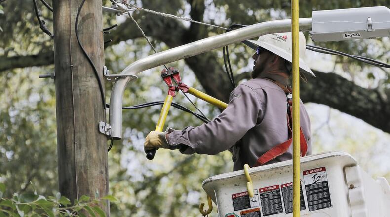 A Georgia Power crew works to repair downed power lines in southeast Atlanta in 2018. Bob Andres / bandres@ajc.com