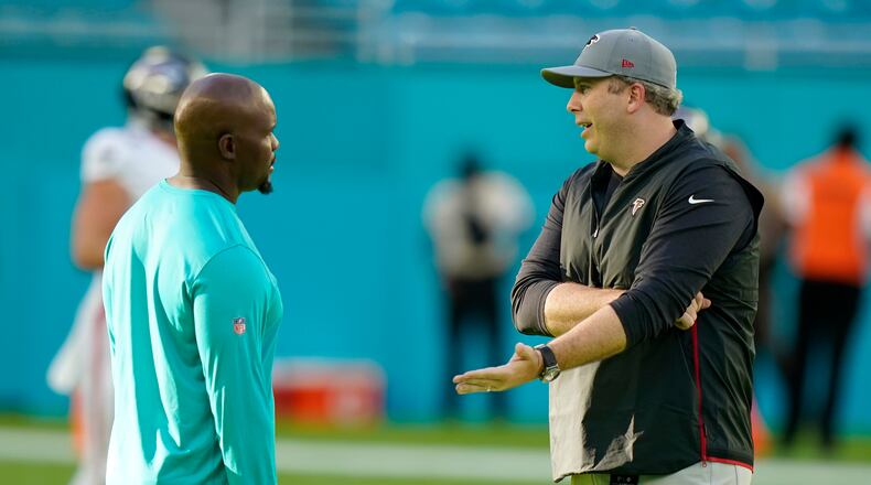 Miami Dolphins head coach Brian Flores, left, talks to Atlanta Falcons head coach Arthur Smith before a NFL preseason football game, Saturday, Aug. 21, 2021, in Miami Gardens, Fla. (AP Photo/Wilfredo Lee)
