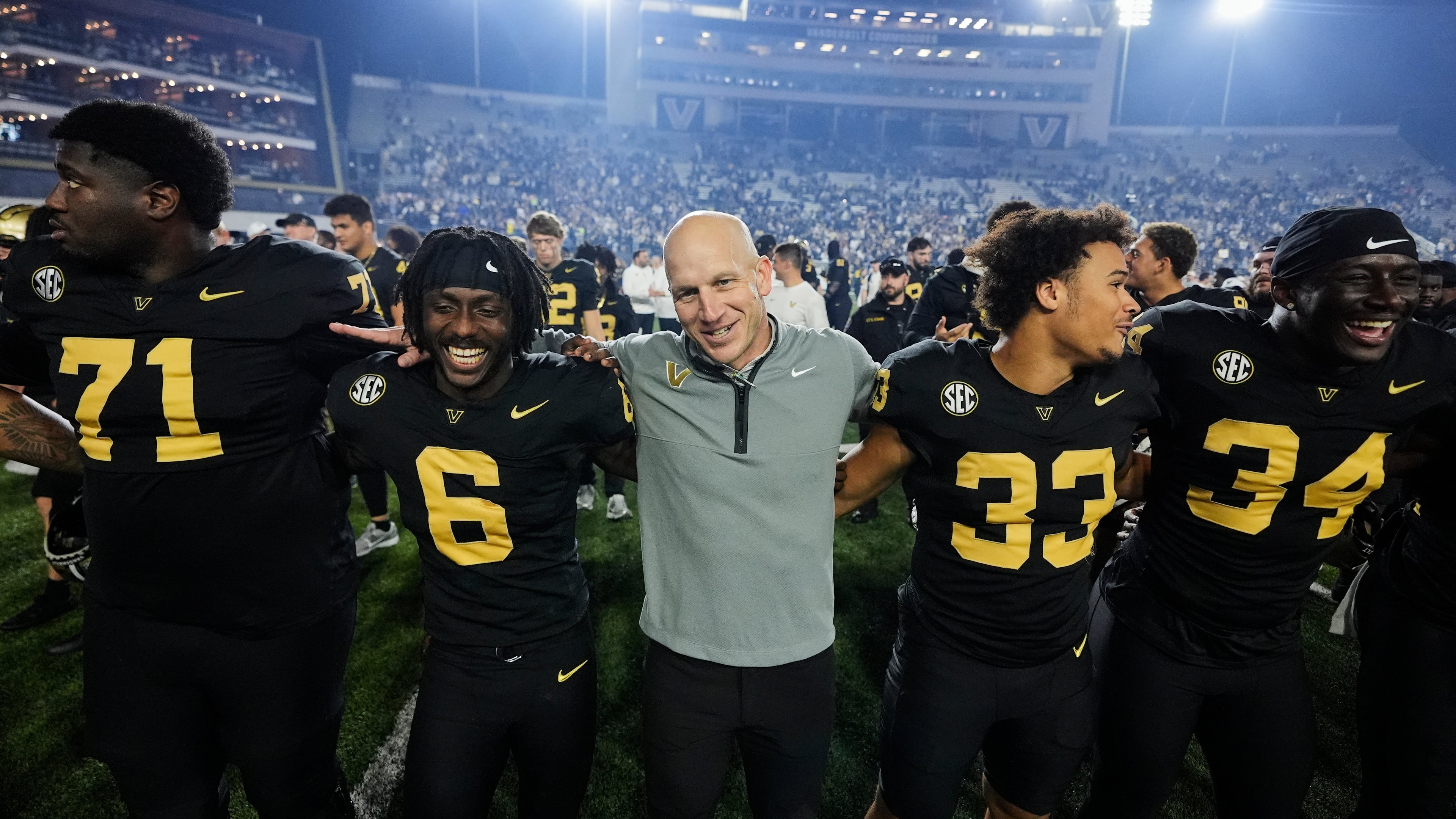 Vanderbilt head coach Clark Lea, center, celebrates the team's win with players after an NCAA college football game against Kentucky, Saturday, Nov. 22, 2025, in Nashville, Tenn. (AP Photo/George Walker IV)