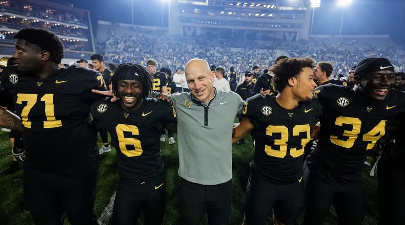 Vanderbilt head coach Clark Lea, center, celebrates the team's win with players after an NCAA college football game against Kentucky, Saturday, Nov. 22, 2025, in Nashville, Tenn. (AP Photo/George Walker IV)
