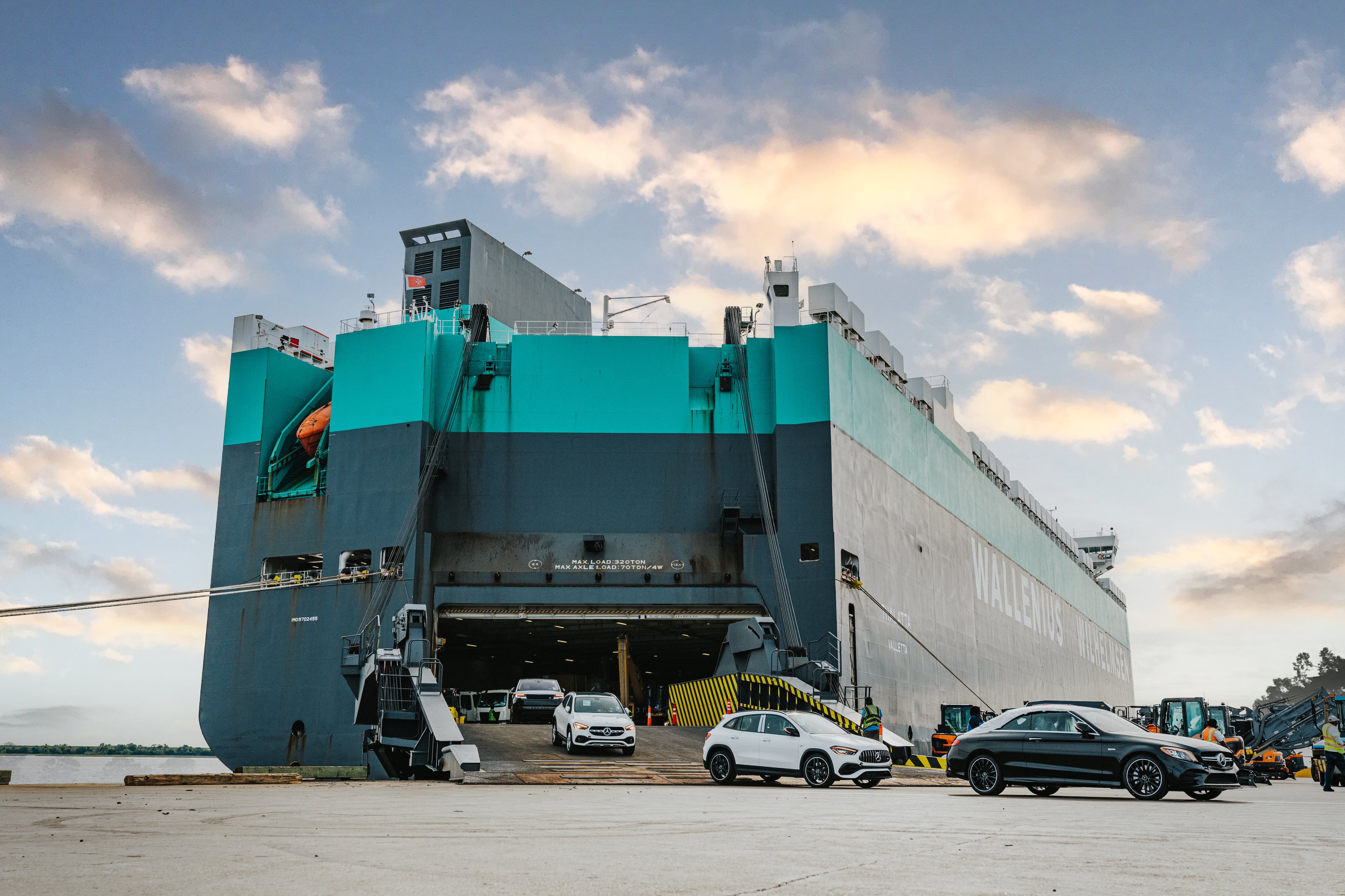 New automobiles offload from a ship docked at the Colonel's Island terminal in Brunswick. Soot and silt have accumulated to the point that the largest vessels must wait for high tide to access the port. (Courtesy of Georgia Ports Authority)