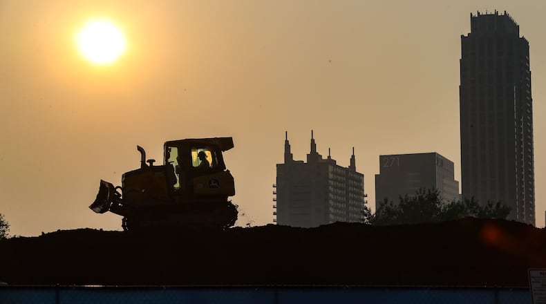 June 30, 2023 Atlanta: A hazy sunrise greeted workers at 480 17th St. in Atlanta Where CBG construction workers are building an apartment complex. The heat was on Friday, June 30, 2023 as temperatures again reached into the mid 90s. Channel 2 Action News meteorologist Ashley Kramlich said that typical high temperatures are in the upper 80s this time of year but Friday’s temperatures soared into the mid-90’s. “And it’s only going up from here,” Kramlich said of the heat forecast headed into July Fourth. “On top of that, humidity is increasing, that’s going to lead to dangerous heat index levels throughout the weekend, and we have a chance for a few showers and thunderstorms in the forecast. A Code Orange air quality alert was issued again Friday as an hazy Atlanta skyline had the Canada wild fires and heat as contributors. Under those conditions, the outdoor air quality is likely to be unhealthy for sensitive groups, including children and people with heart or lung disease. Those groups should limit prolonged outdoor exertion during the late afternoon or early evening when ozone concentrations are highest, according to the National Weather Service. (John Spink / John.Spink@ajc.com)