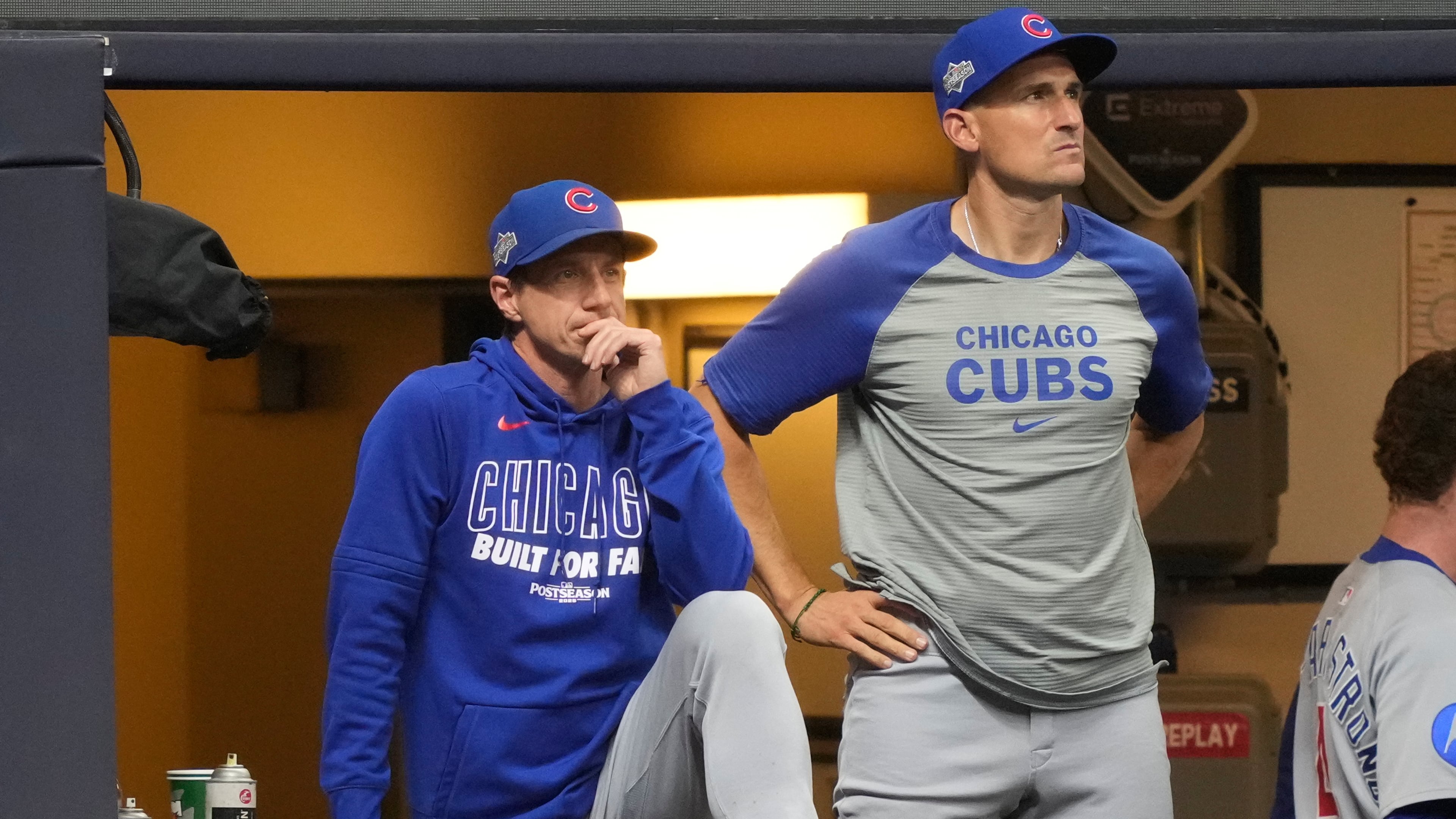 Chicago Cubs manager Craig Counsell, left, and bench coach Ryan Flaherty, right, look on from the dugout during the seventh inning of Game 5 of baseball's National League Division Series against the Milwaukee Brewers, Saturday, Oct. 11, 2025, in Milwaukee. (AP Photo/Kayla Wolf)