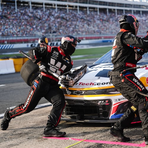 FILE - The pit crew for Shane van Gisbergen (88) rushes to complete a pit stop during a NASCAR Cup Series auto race at Charlotte Motor Speedway, Oct. 5, 2025, in Concord, N.C. (AP Photo/Matt Kelley, File)
