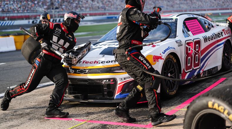 FILE - The pit crew for Shane van Gisbergen (88) rushes to complete a pit stop during a NASCAR Cup Series auto race at Charlotte Motor Speedway, Oct. 5, 2025, in Concord, N.C. (AP Photo/Matt Kelley, File)