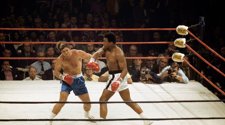 Muhammad Ali delivers a hard right to Jerry Quarry on Oct. 26, 1970, in a scheduled 15 round fight at the Atlanta Municipal Auditorium in Atlanta. Ali was declared the winner after Quarry didn’t answer the bell for the fourth round. Quarry had a gash over his left eye that required 11 stitches to close. (AP Photo/Joe Holloway Jr.)