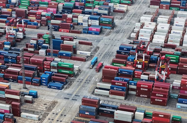 Trucks loaded with container move through a container terminal port in Shanghai, China Monday, June 9, 2025. (Chinatopix Via AP)