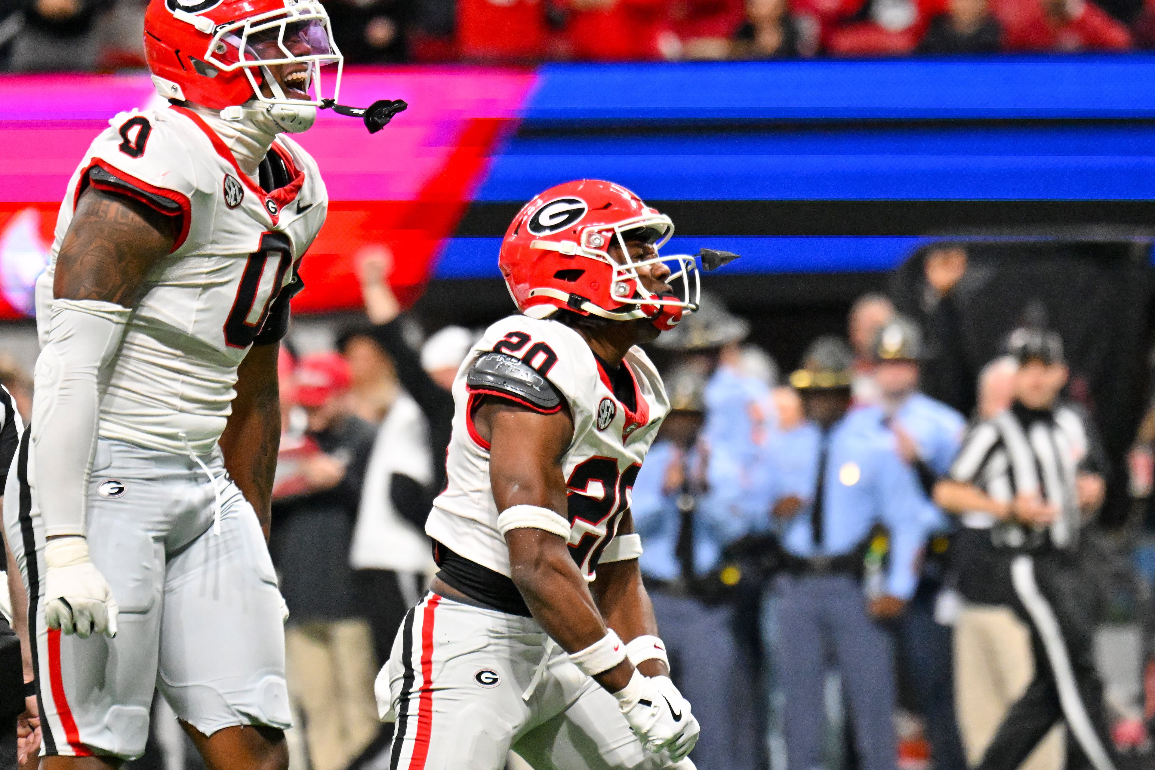 Georgia defensive back Jacorey Thomas (20) reacts after sacking Alabama quarterback Ty Simpson during the third quarter of the SEC Championship game at Mercedes-Benz Stadium, Saturday, Dec. 6, 2025, in Atlanta. Georgia linebacker Gabe Harris Jr. (0) backs him op on the play. (Hyosub Shin / AJC)