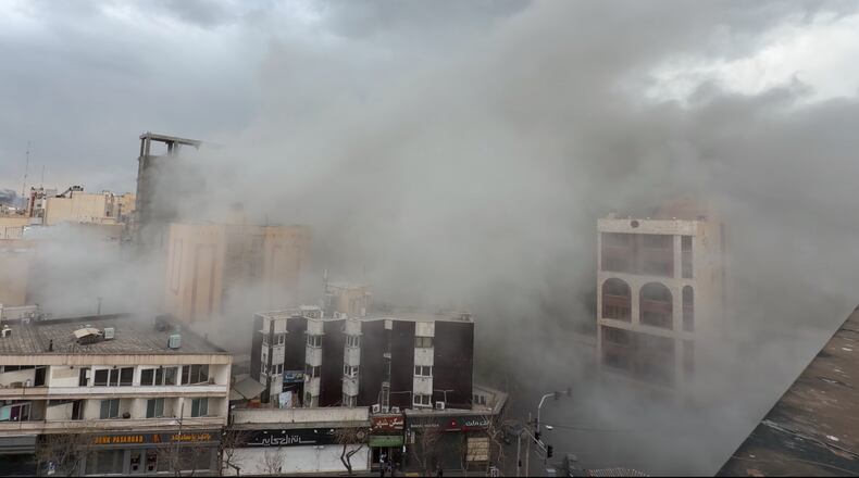 Smoke engulfs a street after a strike in Tehran, Iran, Monday, March 2, 2026. (AP Photo/Mohsen Ganji)