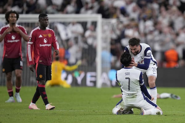 Tottenham's Son Heung-min and Tottenham's Rodrigo Bentancur celebrate at the end of the Europa League final soccer match between Tottenham Hotspur and Manchester United at the San Mames Stadium in Bilbao, Spain, Wednesday, May 21, 2025. (AP Photo/Bernat Armangue)