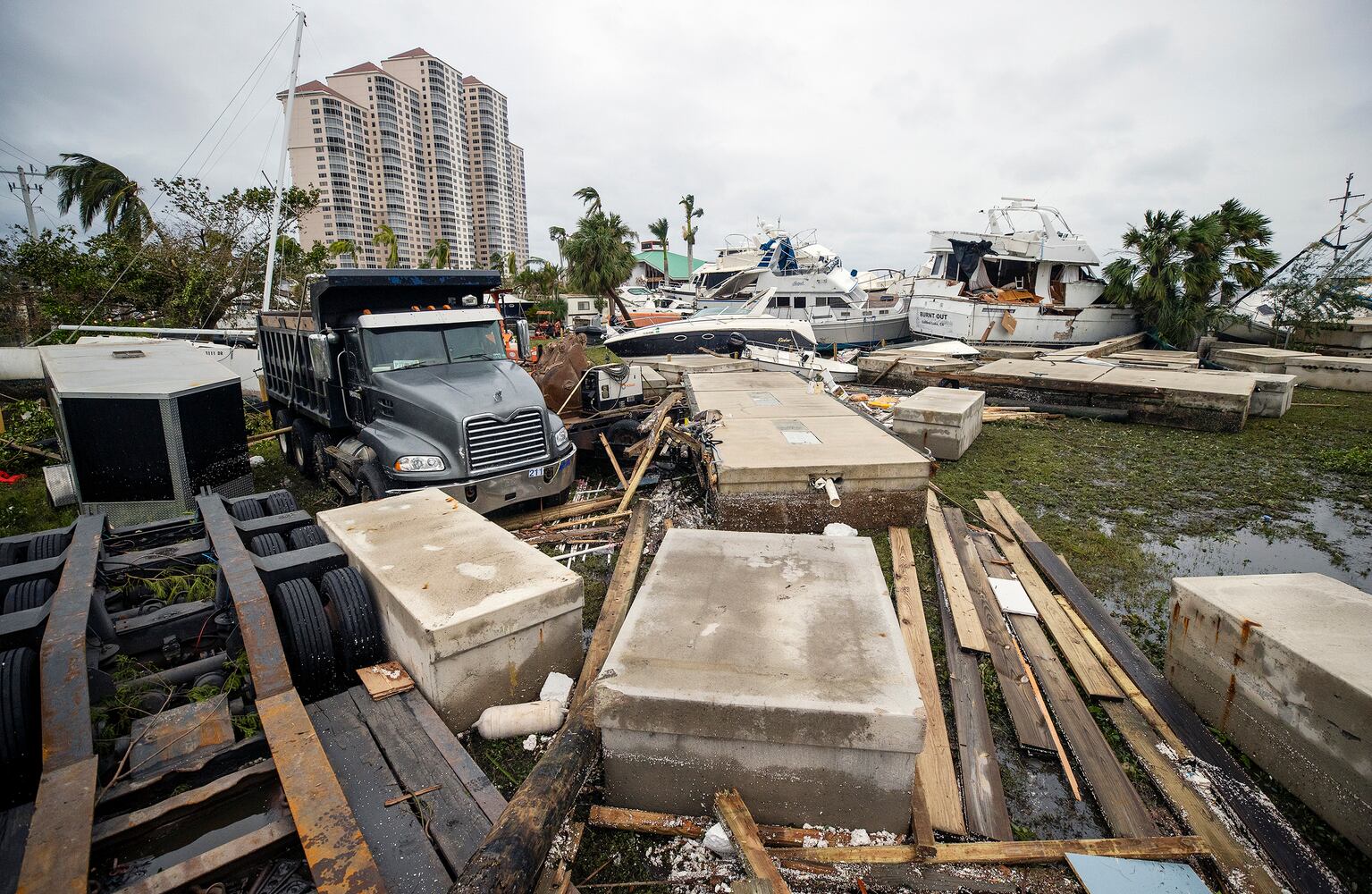 Boats and debris lay smashed against the banks of the Caloosahatchee River in downtown Fort Myers, Fla. after Hurricane Ian passed through on Thursday, Sept. 29, 2022. (Kinfay Moroti/The New York Times)