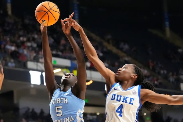 North Carolina forward Maria Gakdeng (5) an Duke guard Jadyn Donovan (4) battle under the basket during the first half in the Sweet 16 of the NCAA college basketball tournament, Friday, March 28, 2025, in Birmingham, Ala. (AP Photo/Gerald Herbert)