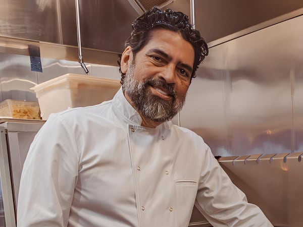 Chef Hector Santiago poses in his kitchen.