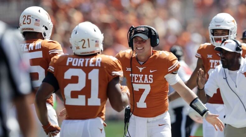 Texas quarterback Shane Buechele (7) celebrates with teammates after a score against San Jose State during the first half of an NCAA college football game, Saturday, Sept. 9, 2017, in Austin, Texas. Texas won 56-0. (AP Photo/Eric Gay)