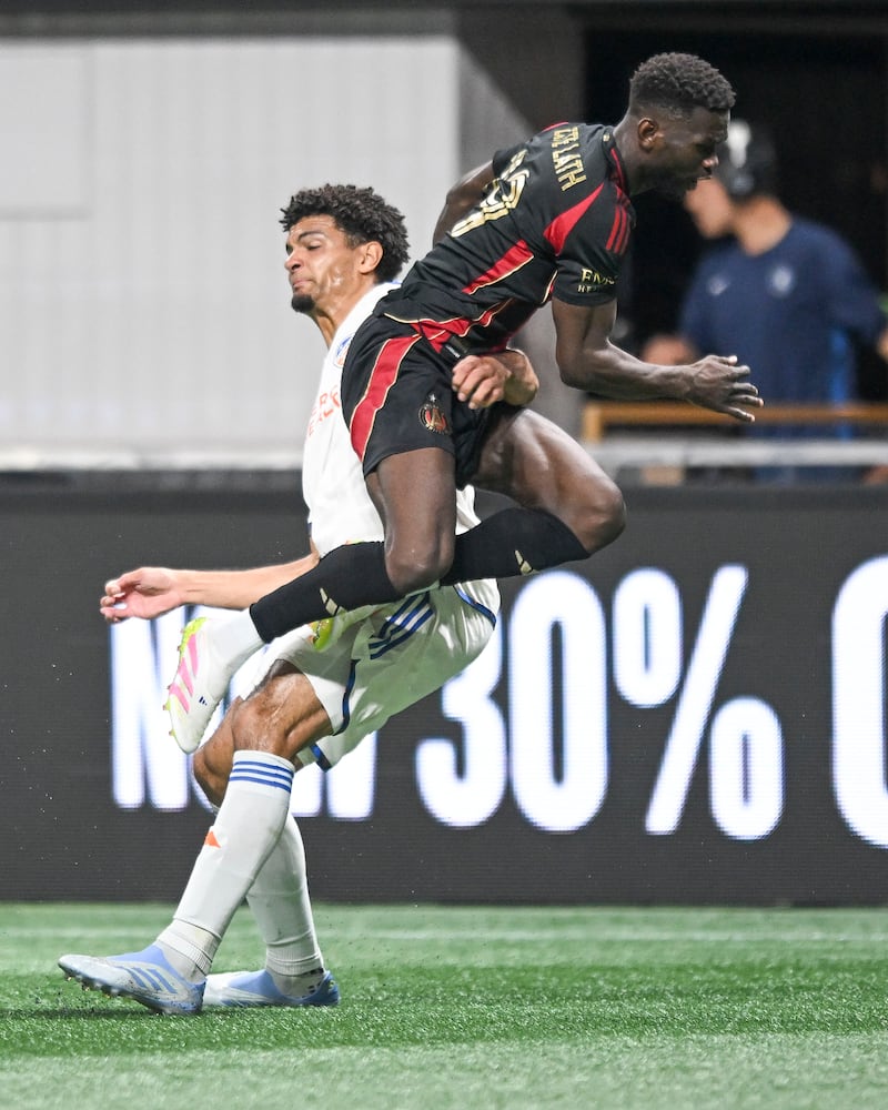 Atlanta United forward Emmanuel Latte Lath (19) collides midair with FC Cincinnati defender Miles Robinson (12) during the second half of a MLS soccer game Sunday, May 25, 2025 at the Mercedes-Benz Stadium. (Daniel Varnado/For the Atlanta Journal-Constitution)