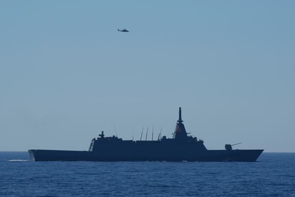 A Philippine navy helicopter flies near the Japanese Maritime Self-Defence Force (JMSDF) frigate JS Noshiro during the Philippines United States Japan Multilateral Maritime Cooperative Activity off a disputed South China Sea shoal on Friday, March 28, 2025. (AP Photo/Aaron Favila)w