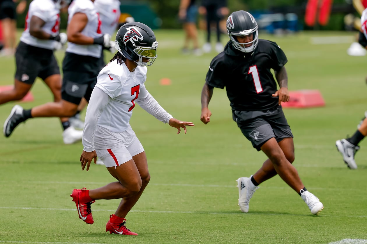 Falcons running back Bijan Robinson (left) and quarterback Tua Tagovailoa participate in practice on Monday, June 8, 2026, in Flowery Branch. Tagovailoa’s accuracy has long been his calling card, and it was on full display this summer. (Erik S. Lesser for the AJC)