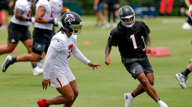Falcons running back Bijan Robinson (left) and quarterback Tua Tagovailoa participate in practice on Monday, June 8, 2026, in Flowery Branch. Tagovailoa’s accuracy has long been his calling card, and it was on full display this summer. (Erik S. Lesser for the AJC)