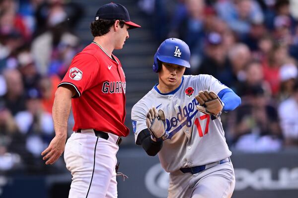 Los Angeles Dodgers' Shohei Ohtani (17) reacts after scoring on an RBI single by Freddie Freeman during the sixth inning of a baseball game against the Cleveland Guardians, Monday, May 26, 2025, in Cleveland. (AP Photo/David Dermer)