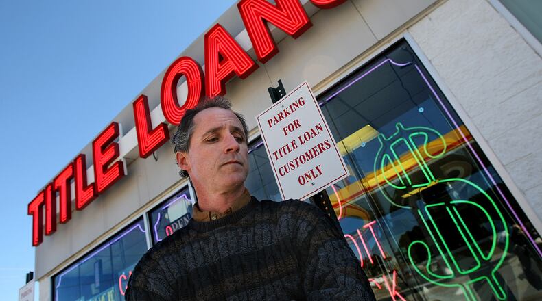 Scott Oden, 42, stands outside the Title Loans business on Scenic Highway in Lawrenceville, Ga., on Wednesday, Jan. 21, 2009, that repossessed his family's Ford Expedition after falling behind on the first two payments. CURTIS COMPTON / ccompton@ajc.com