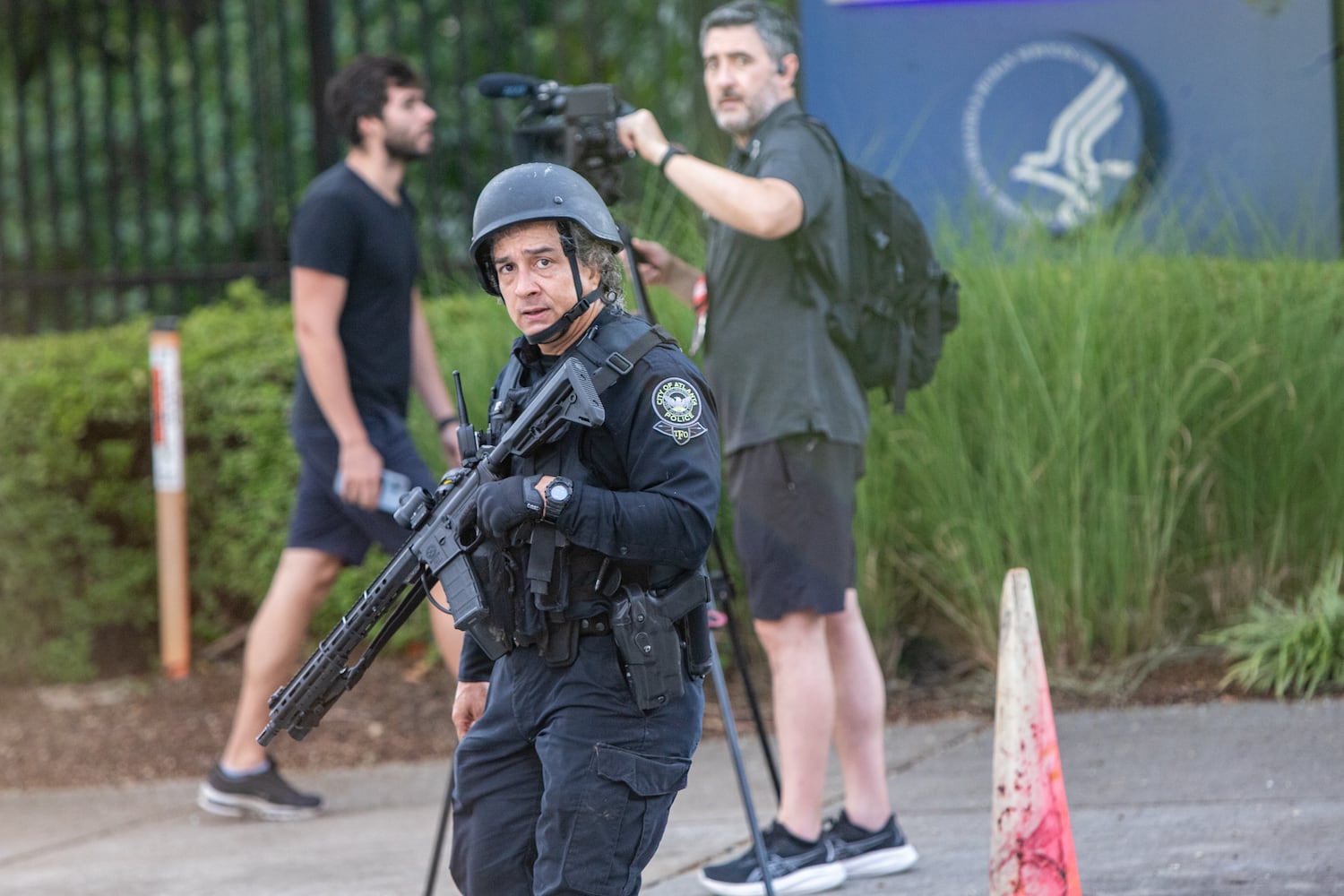 Law enforcement responds to an "active shooter" incident on Clifton Road near the CDC main entrance and Emory Point, which has housing for many Emory students, shopping, restaurants a CVS and day care center, on Friday, Aug 8, 2025. (Jenni Girtman for The Atlanta Journal-Constitution)