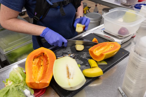 Animal nutrition tech Chandlar Carlile prepares fruits and vegetables for animals at Zoo Atlanta in Atlanta on Tuesday, July 1, 2025. (Arvin Temkar/AJC)
