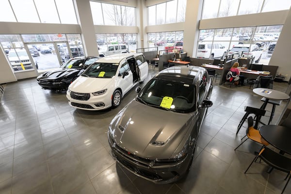 Cars sit in the showroom at the Golling Chrysler Dodge Jeep Ram dealership in Bloomfield Hills, Mich. Dealerships can offer premium customizations or added services as a way to charge consumers more. (David Guralnick/The Detroit News/TNS)
