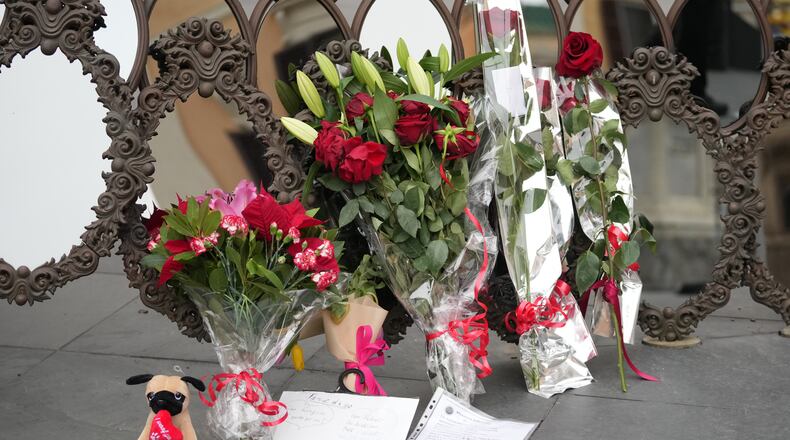 Flowers and messages are placed in front of the Valentino Garavani and Giancarlo Giammetti foundation headquarters during the lying in state of the fashion designer Valentino Garavani in Rome, Wednesday Jan. 21, 2026. (AP Photo/Andrew Medichini)