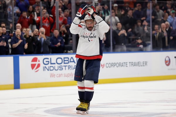 Washington Capitals left wing Alex Ovechkin (8) celebrates after scoring his 895th career goal during the second period of an NHL hockey game against New York Islanders in Elmont, N.Y., Sunday, April 6, 2025. (AP Photo/Adam Hunger)