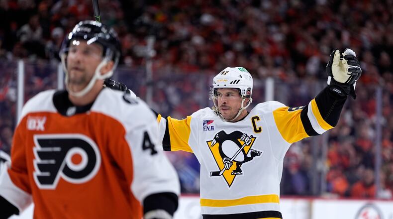 Pittsburgh Penguins' Sidney Crosby, right, reacts behind Philadelphia Flyers' Luke Glendening after scoring during the first period of Game 4 in the first round of the NHL Stanley Cup hockey playoff series Saturday, April 25, 2026, in Philadelphia. (AP Photo/Matt Slocum)