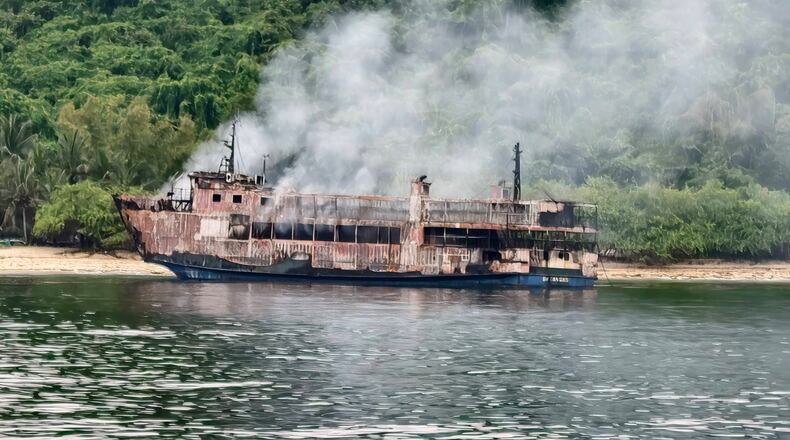 In this photo provided by the Philippine Coast Guard, ferry MV June Aster smolders off Palawan province, western Philippines, Friday, Sept. 11, 2026, days after it caught fire. (Philippine Coast Guard via AP)