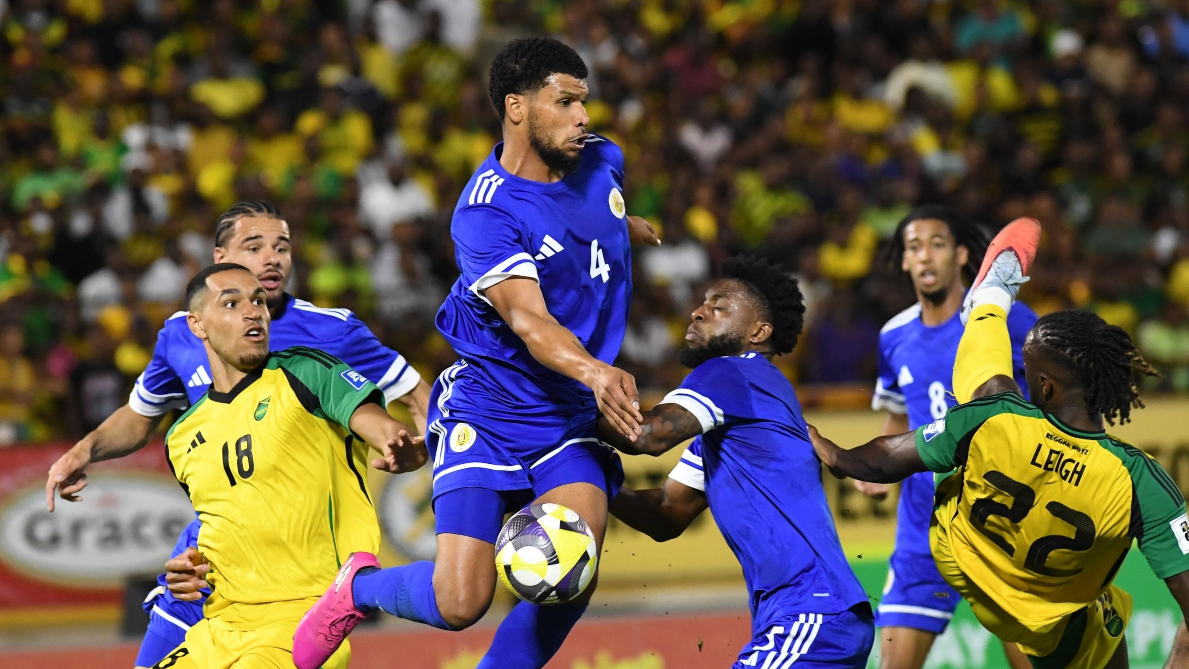 Curacao's Roshon Van Eijma, in the air, fights for the ball with Jamaica's Gregory Leigh, right, and Jonathan Russell during a World Cup 2026 qualifying soccer match in Kingston, Jamaica, Tuesday, Nov. 18, 2025. (AP Photo/Collin Reid)