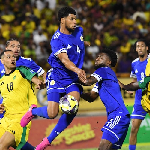 Curacao's Roshon Van Eijma, in the air, fights for the ball with Jamaica's Gregory Leigh, right, and Jonathan Russell during a World Cup 2026 qualifying soccer match in Kingston, Jamaica, Tuesday, Nov. 18, 2025. (AP Photo/Collin Reid)