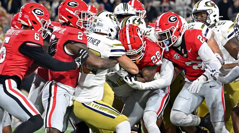 Georgia Tech tight end Brett Seither (80) is brought down by Georgia defense players during the first half of an NCAA college football game at Georgia Tech's Bobby Dodd Stadium, Saturday, November 25, 2023, in Atlanta. (Hyosub Shin / Hyosub.Shin@ajc.com)