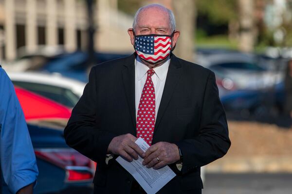 Under federal ethics rules, since his wife has a 1% stake in a family trust, that make U.S. Secretary of Agriculture and former Georgia governor Sonny Perdue a 1% stakeholder in the family's complex, multimillion-dollar business holdings, an Agriculture spokeswoman said. Perdue is seen here preparing to speak at a GOP briefing at Georgia Republican headquarters in Buckhead in November. (Alyssa Pointer / Alyssa.Pointer@ajc.com)