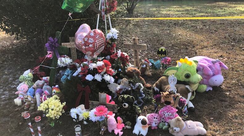 A memorial outside the Effingham County home where two children were found buried in the backyard on December 20, 2018.