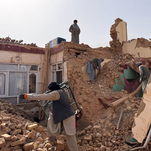 Locals search among the rubble of a destroyed house after a 6.3 powerful in a rural area of the Khulm District, Samangan Province, northern Afghanistan, Monday, Nov. 3, 2025.(AP Photo/Sirat Noori)