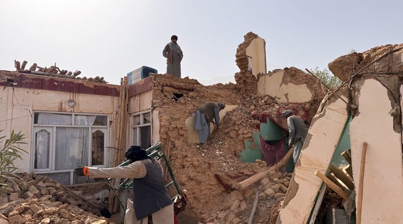 Locals search among the rubble of a destroyed house after a 6.3 powerful in a rural area of the Khulm District, Samangan Province, northern Afghanistan, Monday, Nov. 3, 2025.(AP Photo/Sirat Noori)