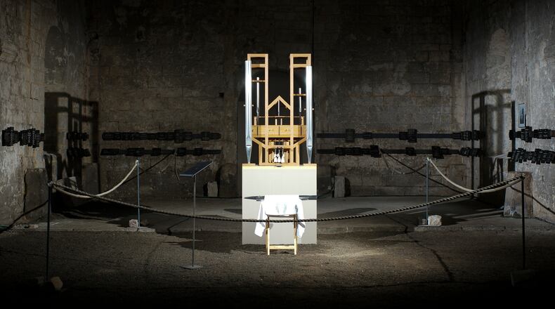 FILE - The organ of the John Cage organ project is illuminated prior to a 'sound change' at the Buchardi Church in Halberstadt, Germany, Sept. 5, 2020. (AP Photo/Markus Schreiber, File)