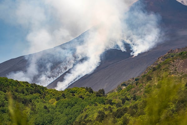 Smoke billows from Mount Etna volcano, Italy, Monday, June 2, 2025. (AP Photo/Giuseppe Distefano)