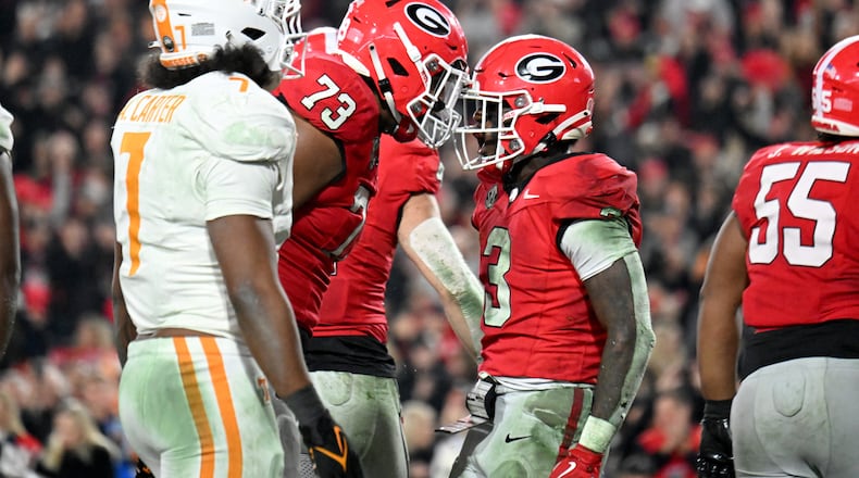 Georgia running back Nate Frazier (3) celebrates with Georgia offensive lineman Xavier Truss (73) after scoring a touchdown during the second half in an NCAA football game at Sanford Stadium, Saturday, November 16, 2024, in Athens. Georgia won 31-17 over Tennessee. (Hyosub Shin / AJC)
