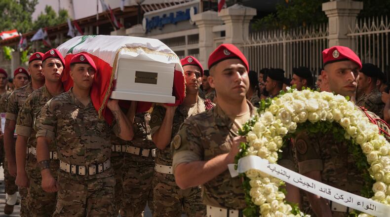 Army soldiers carry the coffin of Brig. Gen. Wissam Sabra, who was killed Saturday in south Lebanon along with a captain and a soldier in an Israeli airstrike, during his funeral procession in Beirut, Sunday, June 7, 2026. (AP Photo/Hassan Ammar)