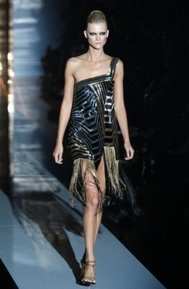Models take the catwalk during Milan Fashion Week 2011