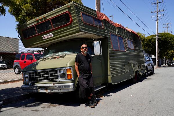 Carlos Perez poses for a photo outside his RV, where he lives, in the Bayview neighborhood of San Francisco, Monday, July 14, 2025. (AP Photo/Terry Chea)