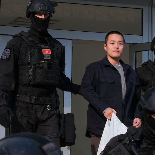 FILE - Montenegrin police officers escort South Korean citizen, Terraform Labs founder Do Kwon in Montenegro's capital Podgorica, March 23, 2024. (AP Photo/Risto Bozovic, File)