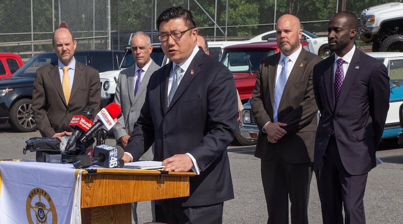 Federal and local authorities announced immigration and weapons charges against businessman Juan Antonio Perez Wednesday at the Bartow County Sheriff’s Office, where they displayed the many pricey firearms and vehicles Perez has amassed while allegedly living in the United States illegally since 1992. STEVE SCHAEFER / SPECIAL TO THE AJC