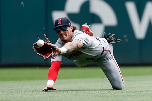 Boston Red Sox outfielder Jarren Duran comes up short as he dives for a line drive by Atlanta Braves' Matt Olson during the fourth inning of a baseball game, Sunday, June 1, 2025, in Atlanta. (AP Photo/Butch Dill)