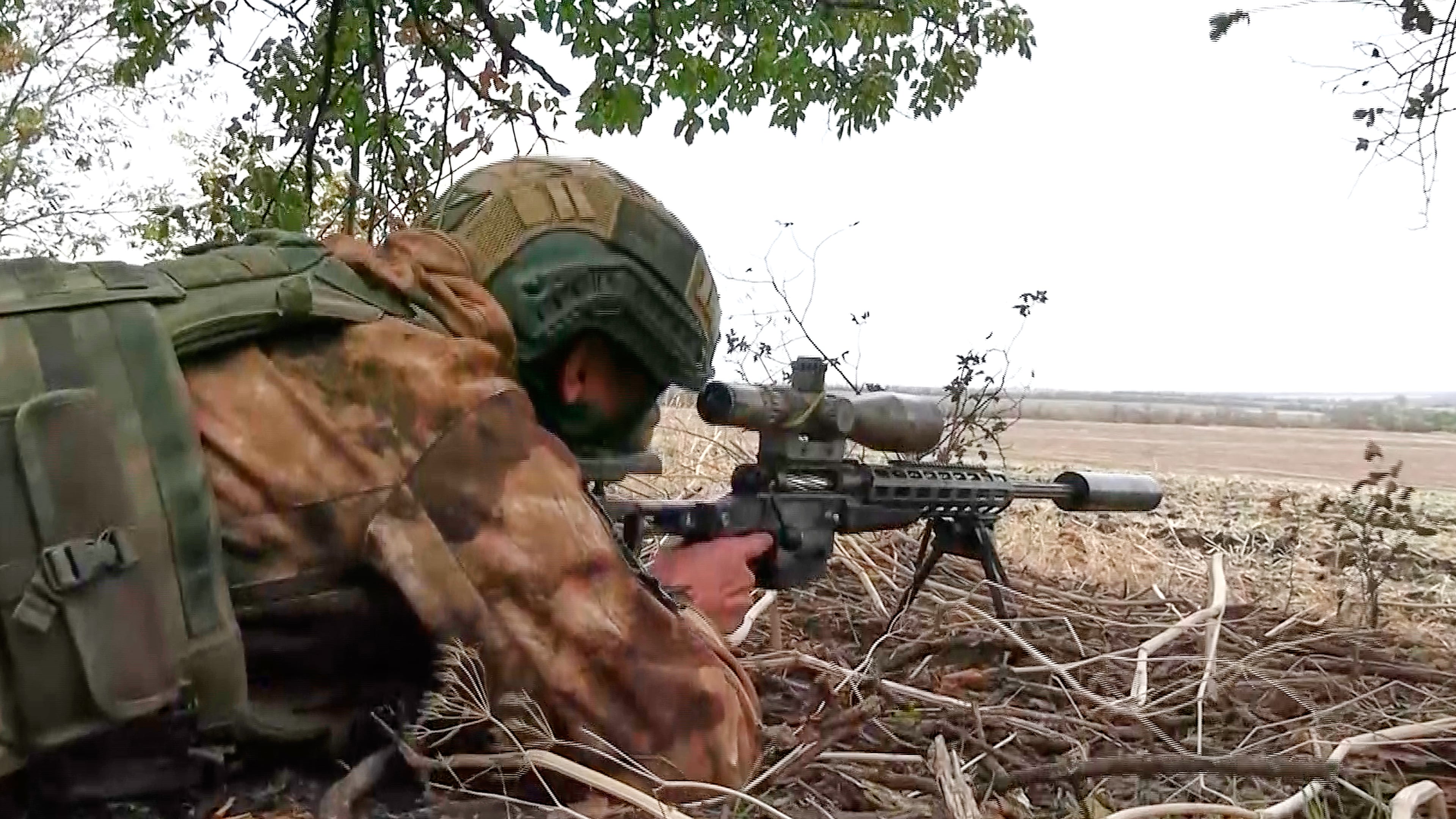 In this photo taken from video distributed by Russian Defense Ministry Press Service on Monday, Oct. 6, 2025, a Russian sniper fires towards Ukrainian forces from an undisclosed location. (Russian Defense Ministry Press Service via AP)
