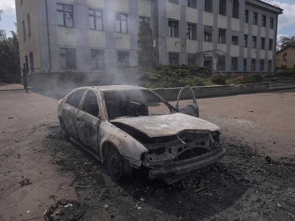 In this photo provided by Ukraine's 93rd Kholodnyi Yar Separate Mechanized Brigade press service, a burnt car with a charred body of a 55-year-old driver inside is seen following the strike of Russian Molniya-1 drone in the center of Kostyantynivka, Donetsk region, Ukraine, Friday, May 16, 2025. (Iryna Rybakova/Ukraine's 93rd Mechanized Brigade via AP)